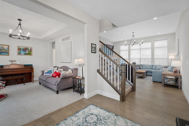 living room with a chandelier and wood-type flooring