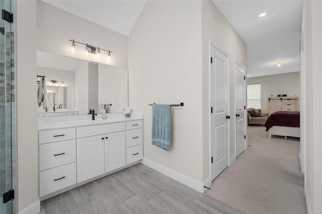 bathroom with lofted ceiling, a shower with shower door, and vanity