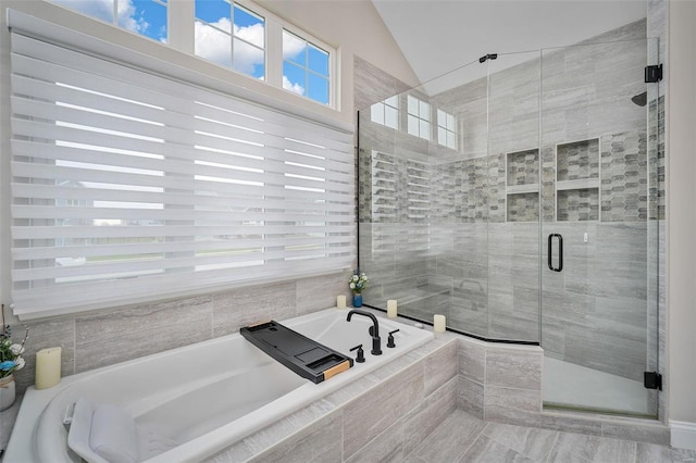 bathroom with shower with separate bathtub and lofted ceiling