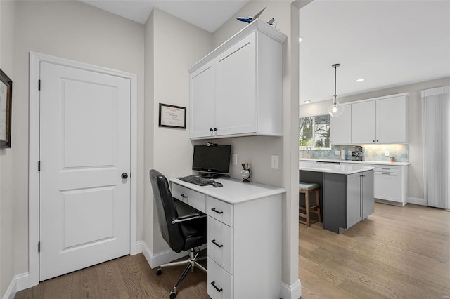 office area with sink and light hardwood / wood-style floors