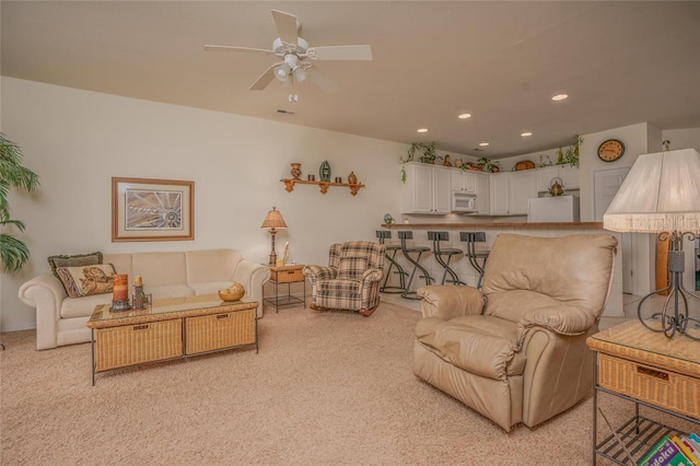 living room with light carpet and ceiling fan