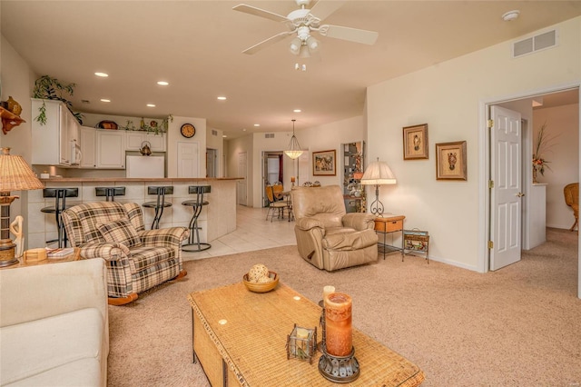 carpeted living room featuring ceiling fan