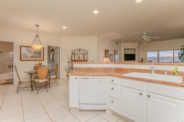 kitchen featuring dishwasher, pendant lighting, white cabinets, and sink