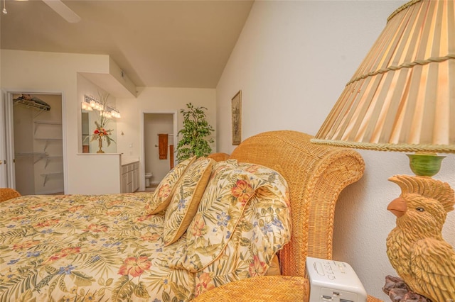 bedroom with ensuite bathroom, a spacious closet, and a closet