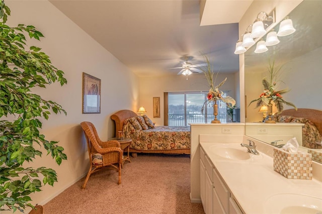 carpeted bedroom featuring ceiling fan and sink