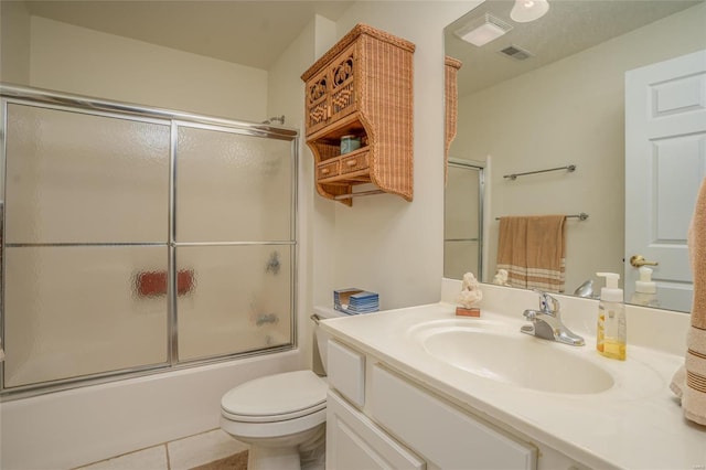 full bathroom featuring tile patterned flooring, vanity, bath / shower combo with glass door, and toilet