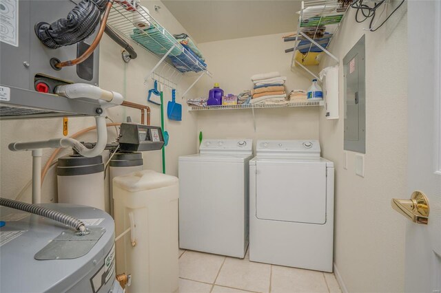 washroom featuring electric panel, light tile patterned flooring, and independent washer and dryer