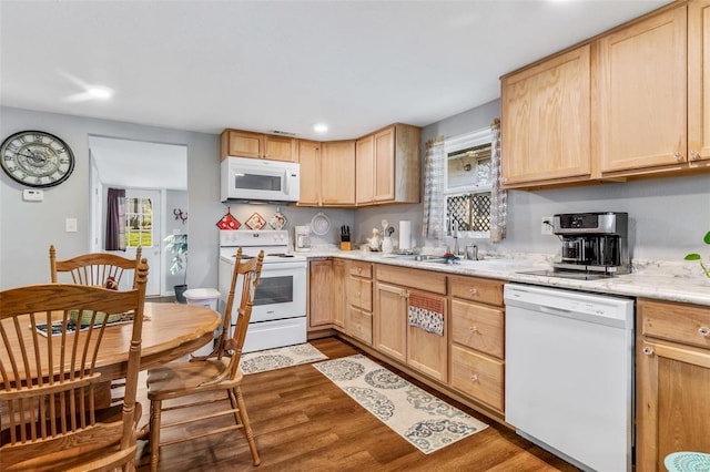 kitchen featuring light brown cabinets, wood-type flooring, white appliances, and sink