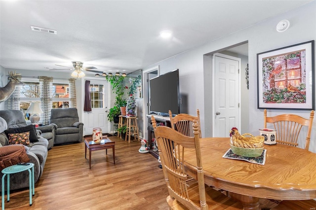 dining room with ceiling fan and light hardwood / wood-style flooring