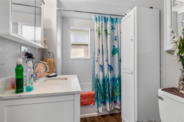 full bathroom with shower / bath combo, toilet, wood-type flooring, and vanity