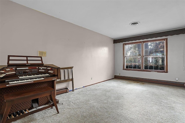 miscellaneous room with light carpet and a baseboard radiator