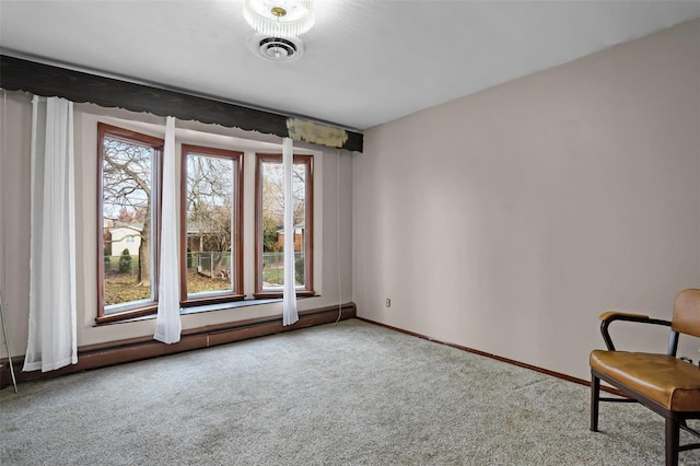 unfurnished room featuring carpet and a baseboard radiator