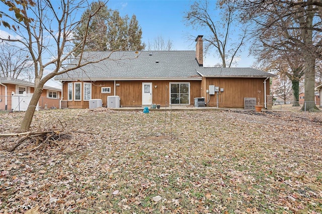 rear view of property with cooling unit