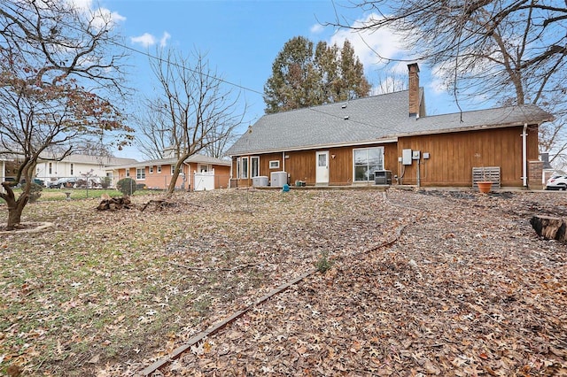 back of house featuring central AC