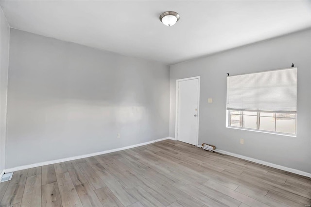 unfurnished room with light hardwood / wood-style floors