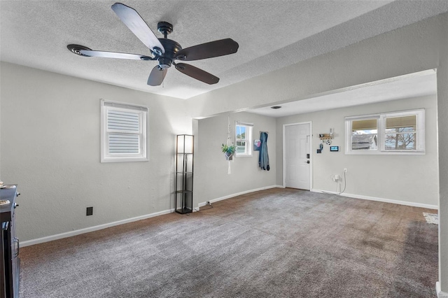 interior space featuring ceiling fan and a textured ceiling