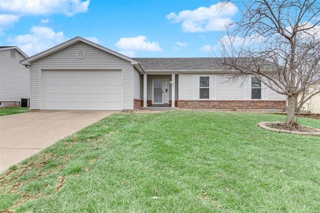 ranch-style home featuring a garage and a front lawn