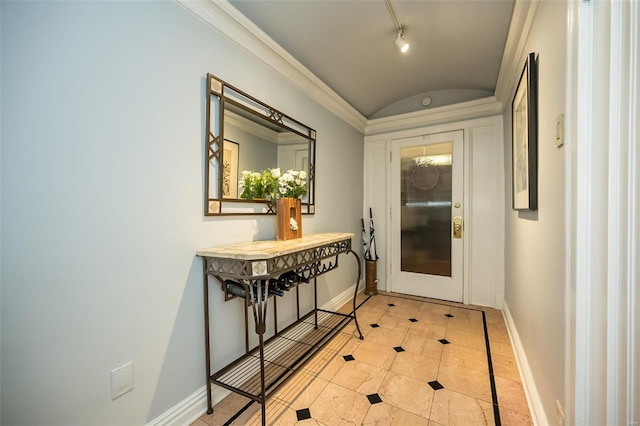 entryway featuring track lighting, light tile patterned floors, crown molding, and vaulted ceiling