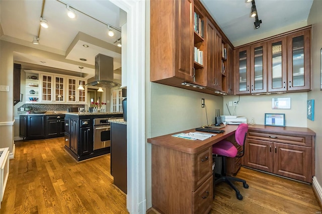 office with dark hardwood / wood-style flooring and rail lighting