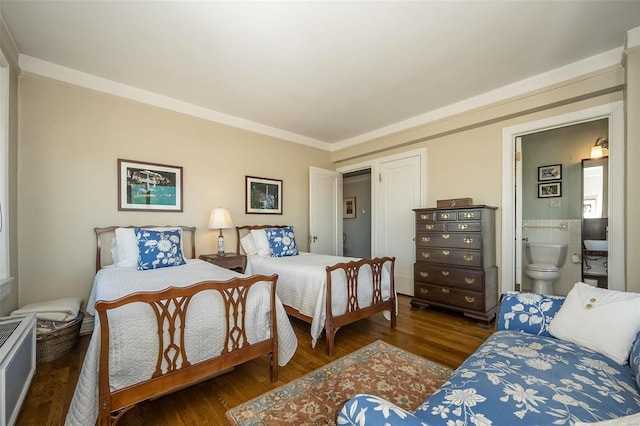 bedroom featuring connected bathroom, crown molding, and dark hardwood / wood-style flooring