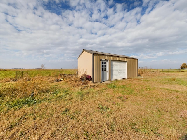 view of outbuilding featuring a rural view and a garage