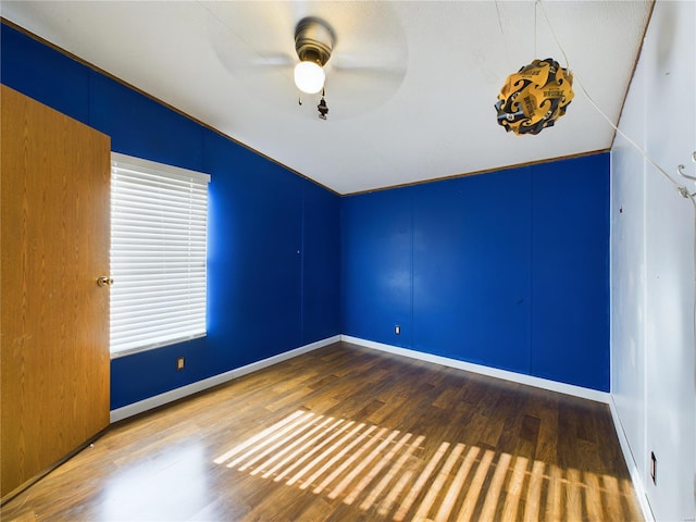 empty room featuring wood-type flooring, a textured ceiling, ceiling fan, and lofted ceiling