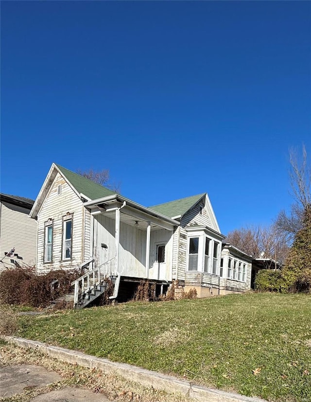 view of side of home with a yard