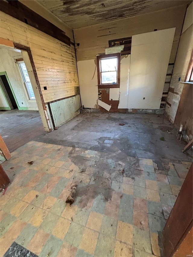 empty room featuring wood walls