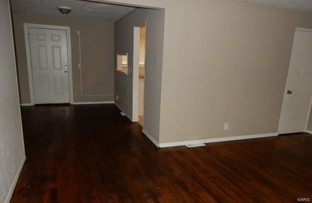 hall featuring dark hardwood / wood-style flooring and a textured ceiling