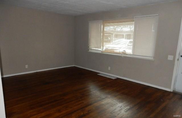 unfurnished room featuring dark hardwood / wood-style floors