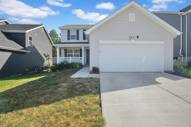 front of property featuring covered porch, a garage, and a front lawn