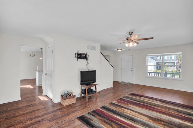 living room featuring ceiling fan and dark hardwood / wood-style floors