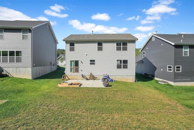 rear view of house with a yard and a patio