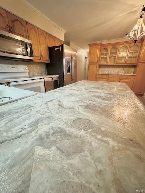 kitchen featuring stainless steel appliances, hanging light fixtures, and ornamental molding