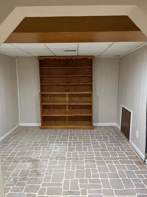 basement featuring a drop ceiling