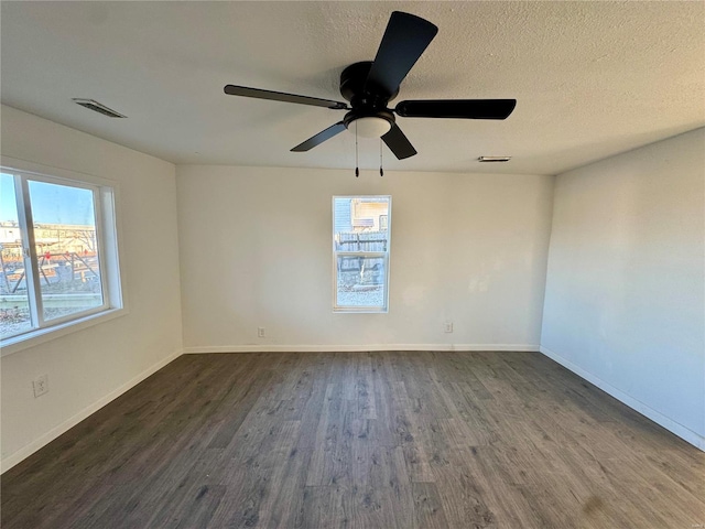 unfurnished room with dark hardwood / wood-style floors, a textured ceiling, and ceiling fan