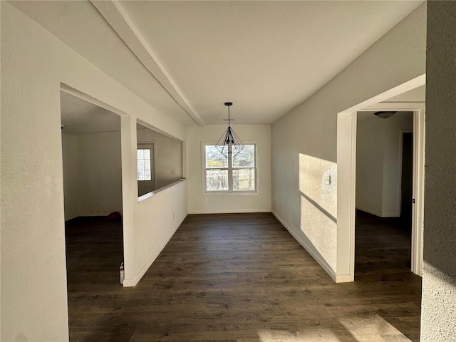 unfurnished dining area with dark wood-type flooring