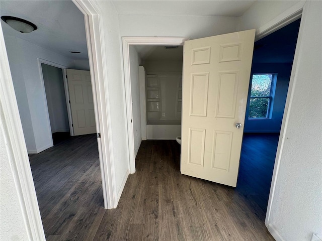 hall with dark hardwood / wood-style floors