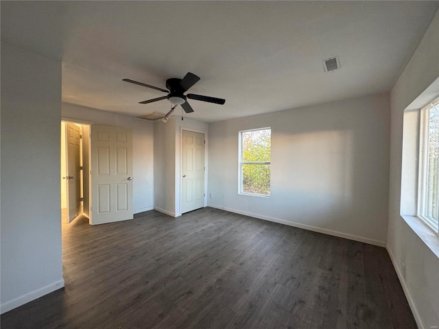 unfurnished bedroom featuring dark hardwood / wood-style flooring and ceiling fan