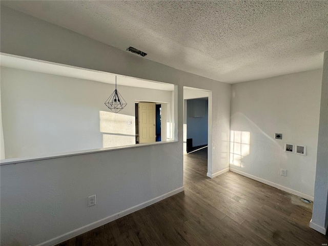 interior space with dark wood-type flooring and a textured ceiling