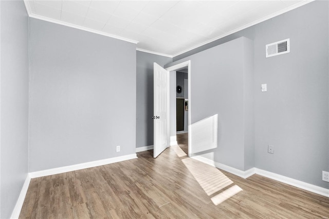 unfurnished room featuring wood-type flooring and crown molding