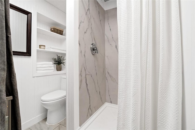 bathroom featuring toilet and walk in shower