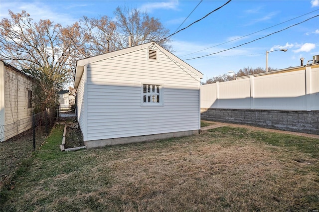 view of outbuilding with a lawn