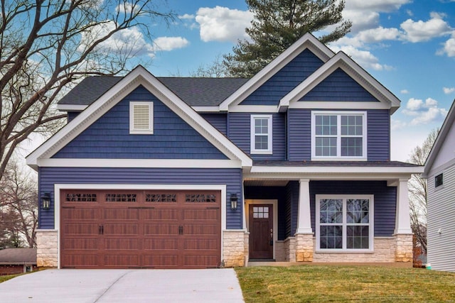 craftsman-style house featuring a garage and a front lawn