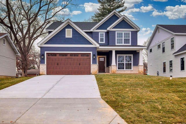 craftsman house featuring a garage and a front yard