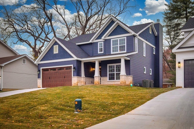 craftsman inspired home with a front yard, a garage, central AC unit, and covered porch