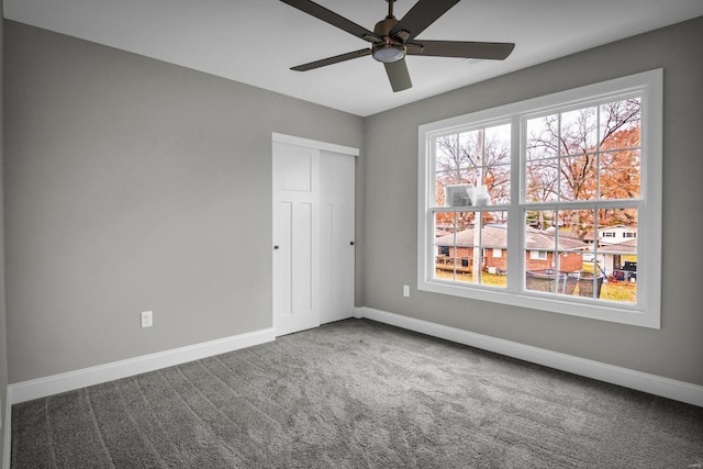 empty room with carpet and ceiling fan