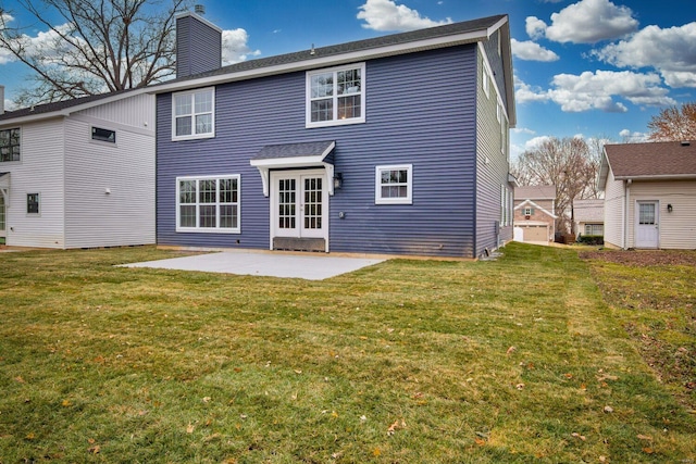 rear view of property featuring a yard and a patio