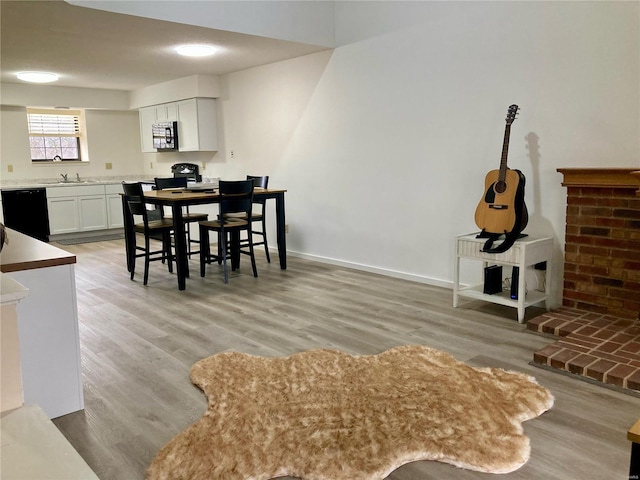 dining room with sink and light wood-type flooring