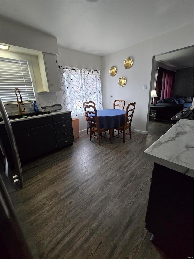 kitchen featuring white cabinets, dark hardwood / wood-style flooring, and sink